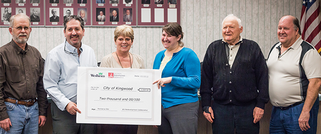 Carrie Staton presenting Kingwood City Council with a redevelopment grant for the city’s recycling program.
